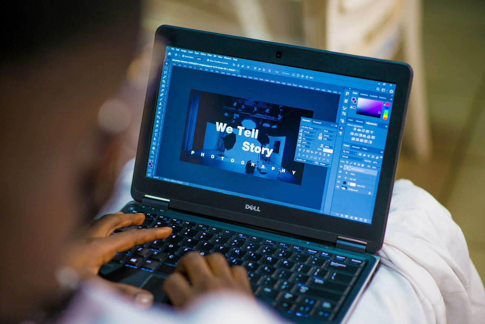 Designer working on a laptop with design software open