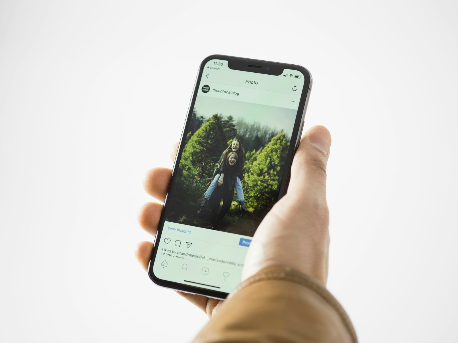 Hand holding an iPhone with the camera app open