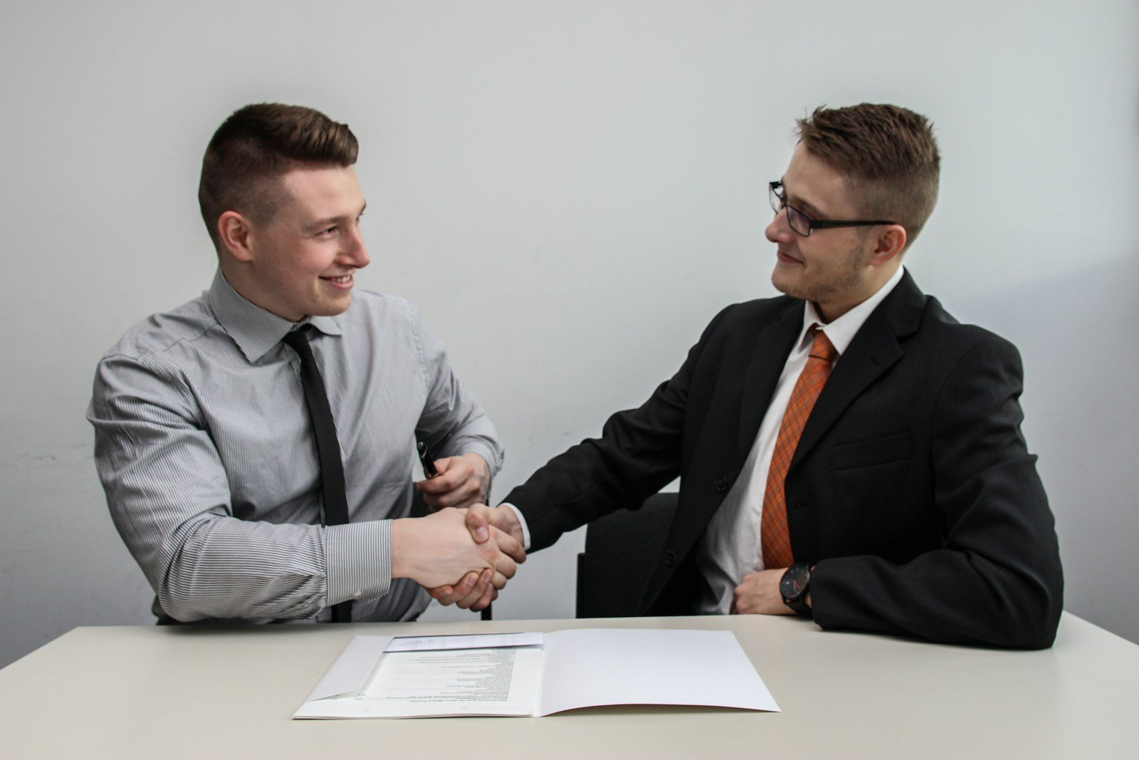 Two professionals exchanging a business card at a networking event