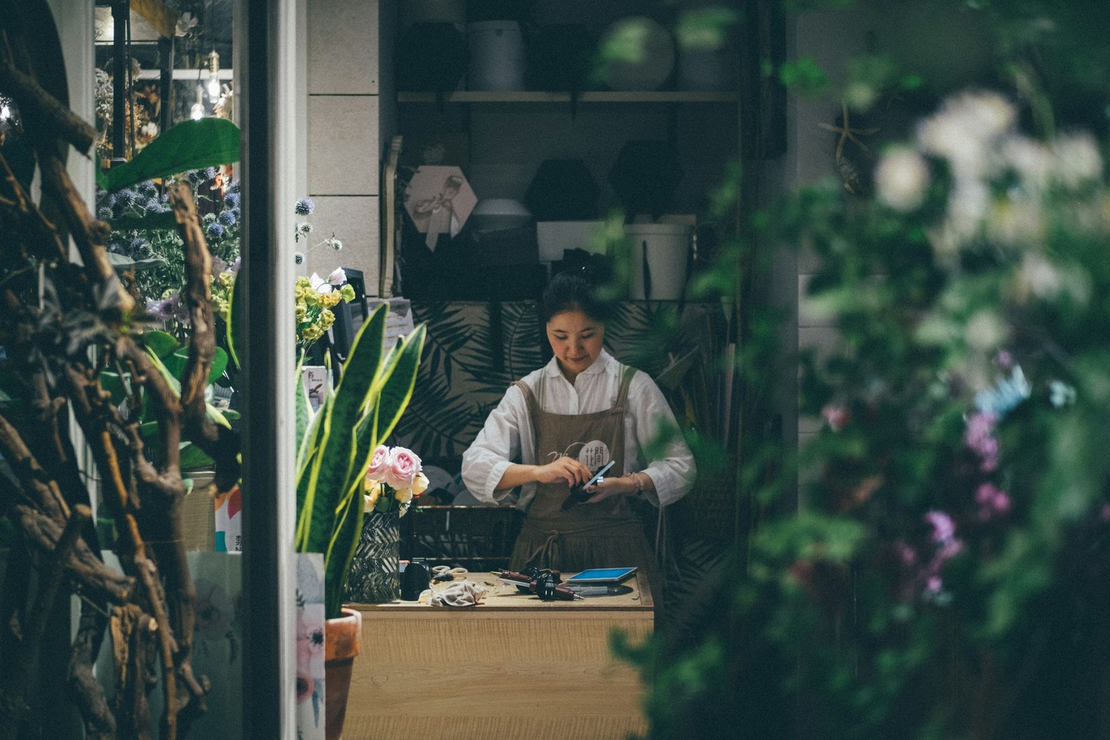 Small business owner standing at a storefront counter
